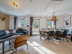 a living room with a couch and a table and chairs at Haus Laura in Donnersbachwald