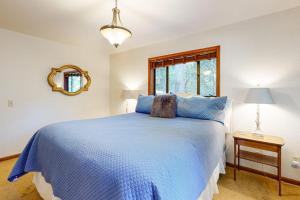 a bedroom with a blue bed and a mirror at Sunrise Mountain Retreat in Cazadero +25 photos