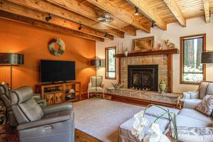 a living room with a tv and a fireplace at Sunrise Mountain Retreat in Cazadero