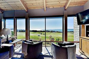 a living room with a large window with a view at Fairview Grande in Bodega Bay