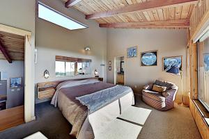 a bedroom with a large bed and a chair at Fairview Grande in Bodega Bay