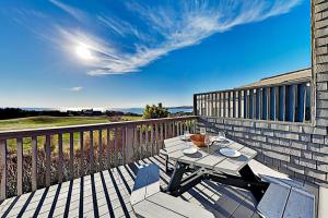 a table and chairs on a deck on a balcony at Fairview Grande in Bodega Bay