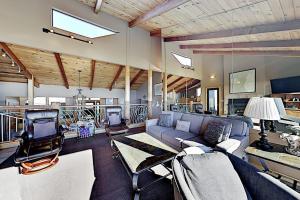 a living room with a blue couch and chairs at Fairview Grande in Bodega Bay