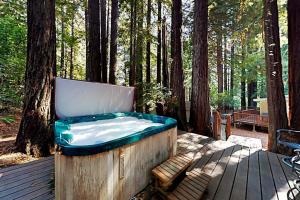 ein Whirlpool auf einer Terrasse im Wald in der Unterkunft Wagging Woods in Cazadero