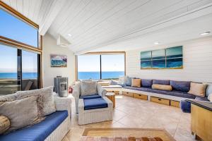 a living room with couches and chairs and the ocean at Blue Horizon in Bodega Bay