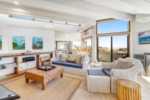 a living room with two couches and a tv at Blue Horizon in Bodega Bay