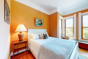 a bedroom with a bed and a lamp on a table at Magnolia Ranch Vineyards in Healdsburg