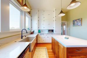 a kitchen with white cabinets and a sink at Magnolia Ranch Vineyards in Healdsburg +18 photos