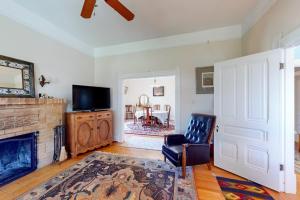 a living room with a fireplace and a tv at Magnolia Ranch Vineyards in Healdsburg