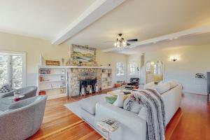 a living room with a white couch and a fireplace at Dragon Cottage in Healdsburg