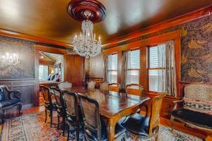 a dining room with a table and chairs and a chandelier at Antler River Lodge in Guerneville