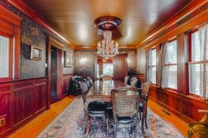 a dining room with a table and chairs and a chandelier at Antler River Lodge in Guerneville