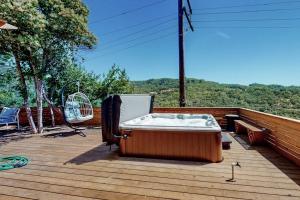 a hot tub sitting on a deck with a chair at Rooster Cottage in Healdsburg