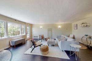 a living room with a couch and a table at Rooster Cottage in Healdsburg