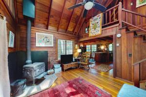 a living room with a stove in a cabin at Dreamcatcher Cottage in Cazadero