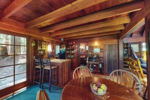 a dining room with a table and chairs in a cabin at Dreamcatcher Cottage in Cazadero +11 photos