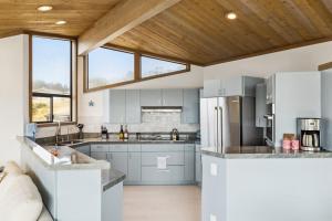 a kitchen with white appliances and a wooden ceiling at Mar Vista in Bodega Bay