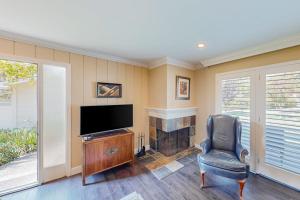 a living room with a television and a chair at Silverado Resort and Spa 381 & 382 in Napa
