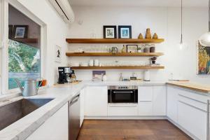 a kitchen with white cabinets and a sink at Rio Lindo River Retreat in Healdsburg +19 photos