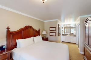 a bedroom with a large white bed and a bathroom at Silverado Resort and Spa 288 in Napa