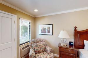a bedroom with a bed and a chair and a window at Silverado Resort and Spa 288 in Napa +29 photos