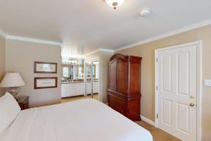 a bedroom with a large white bed and a bathroom at Silverado Resort and Spa 288 in Napa