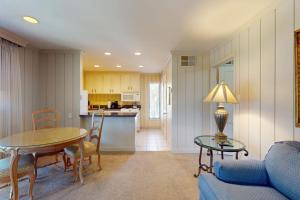 a living room with a table and a kitchen at Silverado Resort and Spa 221 in Napa
