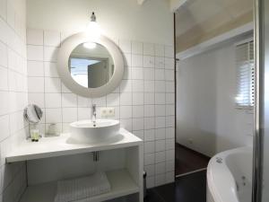 a white bathroom with a sink and a mirror at Le Chemin des Framboises in Malmedy +27 photos