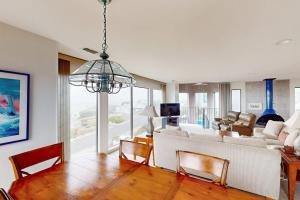 a living room with a white couch and a table at Sea Way Dreams in Bodega Bay
