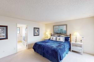a bedroom with a blue bed and two night stands at Sea Way Dreams in Bodega Bay