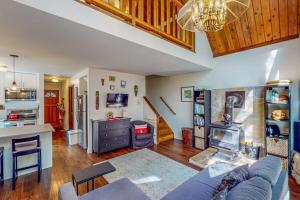 a living room with a blue couch and a kitchen at Cazadero Dreams in Cazadero
