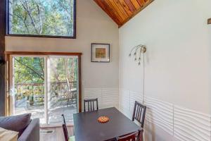 a dining room with a table and a window at Cazadero Dreams in Cazadero +17 photos