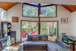 a living room with a blue couch and a table at Cazadero Dreams in Cazadero