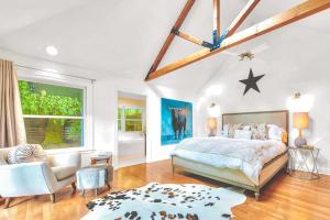 a bedroom with a bed and a couch and a chair at Zegarra Estate in Sebastopol