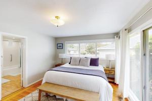 a bedroom with a large bed and a window at Jewell Dreams in Santa Rosa