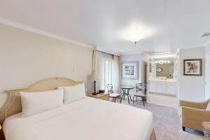 a bedroom with a white bed and a dining room at Silverado Resort and Spa 267 in Napa