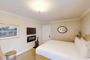 a bedroom with a white bed and a mirror at Silverado Resort and Spa 267 in Napa