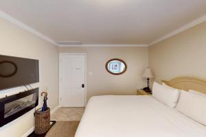 a bedroom with a large white bed and a flat screen tv at Silverado Resort and Spa 267 in Napa