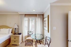 a bedroom with a bed and a glass table and chairs at Silverado Resort and Spa 267 in Napa +24 photos