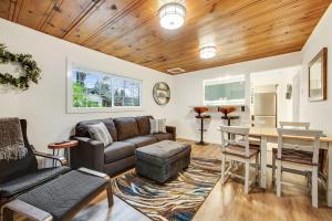 a living room with a couch and a table at Wanderlust Cottage in Guerneville
