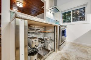 a kitchen with stainless steel appliances and wood ceilings at Wanderlust Cottage in Guerneville