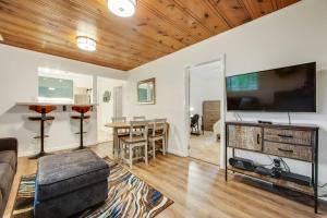 a living room with a large flat screen tv at Wanderlust Cottage in Guerneville