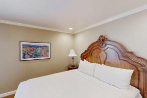 a bedroom with a large bed with a wooden headboard at Silverado Resort and Spa 287 in Napa