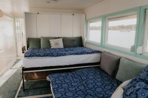 a bedroom with two beds and a couch and a window at Zeleni Biser- Green Pearl in Lukavac