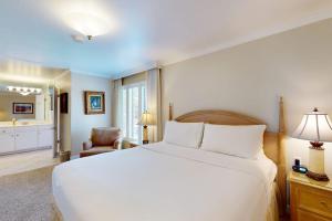 a bedroom with a white bed and a bathroom at Silverado Resort and Spa 266 in Napa