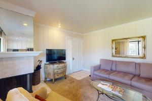 a living room with a couch and a television at Silverado Resort and Spa 266 in Napa +21 photos