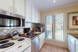a kitchen with white cabinets and a stove top oven at Silverado Resort and Spa 266 in Napa