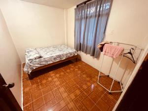 a small room with a bed and a wooden floor at Apt 8 in Tena +2 photos