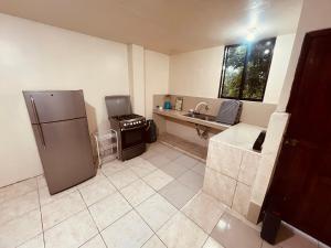 a kitchen with a refrigerator and a sink at Apt 8 in Tena