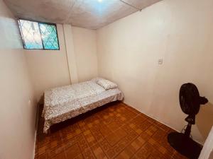 a small bedroom with a bed and a window at Apt 8 in Tena